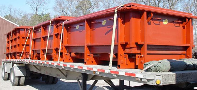 3 tapered core septic tanks heading out on a truck.